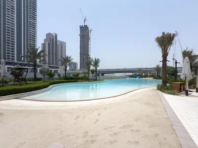 a swimming pool in the middle of the city at GuestReady - Blue Bliss l 2Bed l Lagoon Escape in Dubai