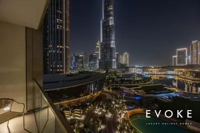 a view of a city skyline at night at Grande Residence Burj View 2 BR by Evoke Luxury in Dubai