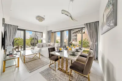 a living room with a table and a couch at Luxury 2BR with Burj Khalifa Views l Near Dubai Mall in Dubai