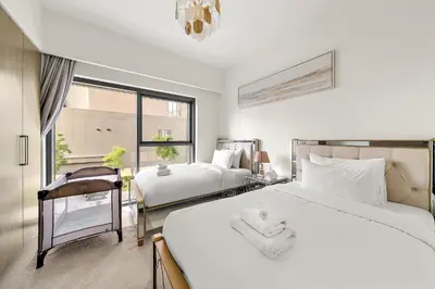 a bedroom with two beds and a window at Luxury 2BR with Burj Khalifa Views l Near Dubai Mall in Dubai