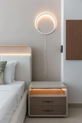 a bedroom with a bed and a mirror on the wall at Cozy Studio in JVC Dubai in Dubai