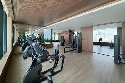 a gym with treadmills and ellipticals in a building at Cozy Studio in JVC Dubai in Dubai