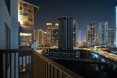 a view of a city skyline at night at GuestReady - 2Bed l Lagoon Escape l Creek Beach in Dubai