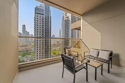 an apartment balcony with chairs and a view of the city at Modern Studio at Elite Downtown Residence in Dubai