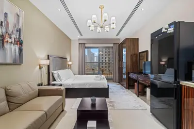 a hotel room with a bed and a desk at Modern Studio at Elite Downtown Residence in Dubai