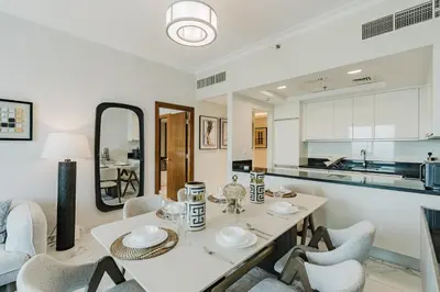 a kitchen and dining room with a table and chairs at RH-Luxury 1BR Apt in Al Habtoor City with beautiful Canal View in Dubai