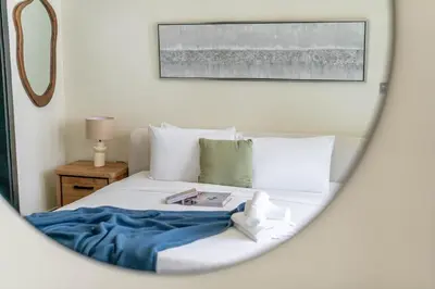 a bedroom with a bed with a mirror at DAYF-MER Stylish 1Bed in central location Business Bay in Dubai