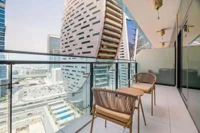 a balcony with two chairs and a view of a city at DAYF-MER Stylish 1Bed in central location Business Bay in Dubai