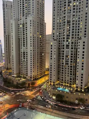 a view of a city with tall buildings at night at LYO guest house Dubai marina BEDSPACE in Dubai