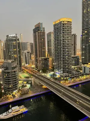 a city with a bridge over a river with buildings at LYO guest house Dubai marina BEDSPACE in Dubai