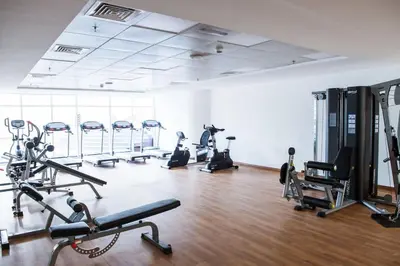 a gym with several treadmills and exercise bikes at Continental Tower Stylish 2BR and Private Hot Tub in Dubai