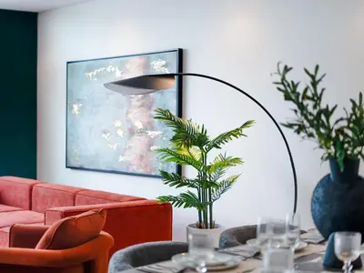 a living room with a red couch and a table with a plant at Private Pool Paradise Villa! Dubai Mall in a Flash! Complimentary Full Mid-Stay Refresh for 1 week stay in Dubai