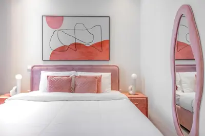 a bedroom with a white bed and a mirror at Private Pool Paradise Villa! Dubai Mall in a Flash! Complimentary Full Mid-Stay Refresh for 1 week stay in Dubai