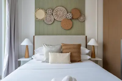 a bedroom with a bed with white sheets and pillows at GuestReady - Creek View l 2Bed l Lagoon Escape in Dubai