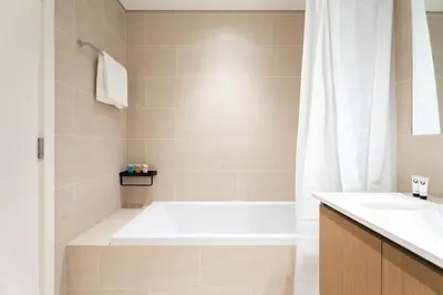 a bathroom with a bath tub and a sink at GuestReady - Creek View l 2Bed l Lagoon Escape in Dubai