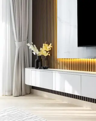 a living room with a tv and a table with flowers at Waves - Luxury Beachfront Escape - Skyline & Sea Views in Dubai