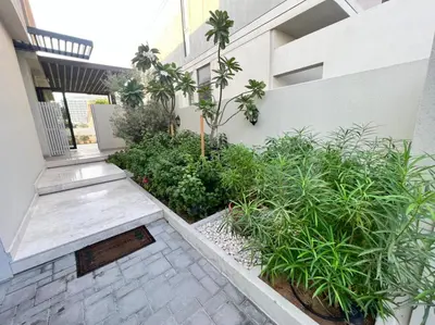 a courtyard of a building with plants and a staircase at Private room in a luxury villa at Dubai hills in Dubai
