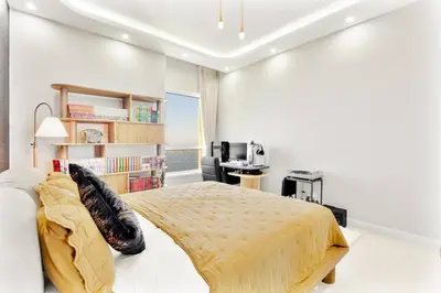 a bedroom with a large bed and a desk at Luxury 2-Bedroom with Sea & Ain Dubai View in Dubai