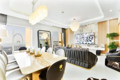a dining room with a table and chairs at Luxury 2-Bedroom with Sea & Ain Dubai View in Dubai