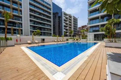 a swimming pool in the middle of a building at Spacious Luxury Escape - Modern Comfort in Riviera in Dubai
