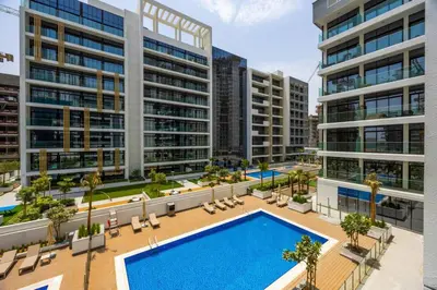 an aerial view of an apartment complex with a swimming pool at Spacious Luxury Escape - Modern Comfort in Riviera in Dubai