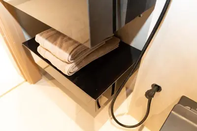 a bathroom with towels on a shelf in a sink at Apartment Studio Blue Wave in Dubai