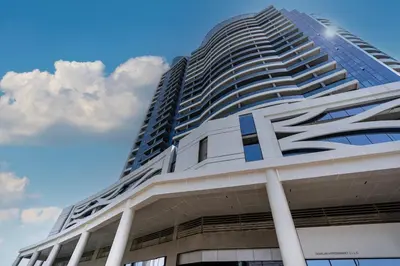a tall building with the letter k on it at Apartment Studio Blue Wave in Dubai