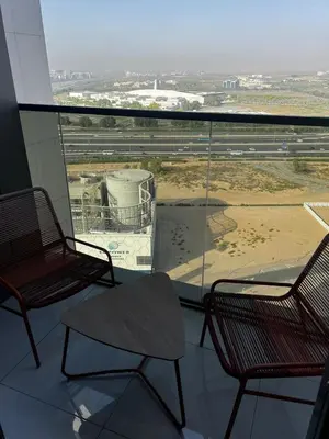 two chairs in a room with a view of an airport at Apartment Studio Blue Wave in Dubai