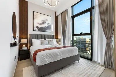 a bedroom with a bed and a large window at Charming 1-Bedroom Close to Downtown in Dubai