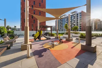 a rendering of a courtyard in a city with buildings at Charming 1-Bedroom Close to Downtown in Dubai