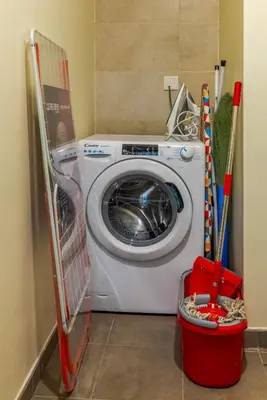 a washer and dryer in a laundry room at High floor, Canal View, Parking, Crib, Dubai Mall & Burj Khalifa in Dubai