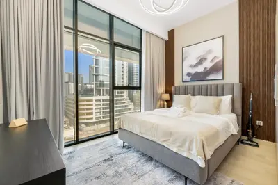 a bedroom with a large bed and a large window at 1 Bedroom Royal Dubai Stay in Dubai