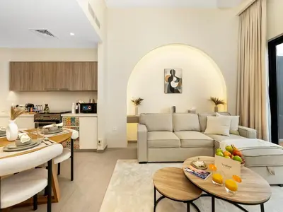 a living room with a couch and a table at Dubai Hills Retreat Garden, Pool & Park Access in Dubai