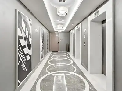 a hallway with a carpeted floor in a building at BLVD - Damac Paramount with Burj Khalifa View in Dubai