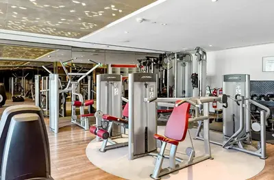 a gym with a bunch of tread machines at BLVD - Damac Paramount with Burj Khalifa View in Dubai