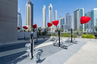 a group of machines on top of a building with a city at Vogue Downtown Mag 318 near Burj Khalifa and Dubai Mall, Studio Apartment with Balcony, Canal and City Skyline View, Access to all Amenities in Dubai