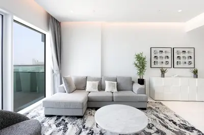 a living room with a couch and a table at Beachfront 2BR with Maids Room One JBR Sea Palm Ain Atlantis Views in Dubai