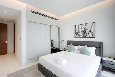 a bedroom with a large white bed in a room at Beachfront 2BR with Maids Room One JBR Sea Palm Ain Atlantis Views in Dubai
