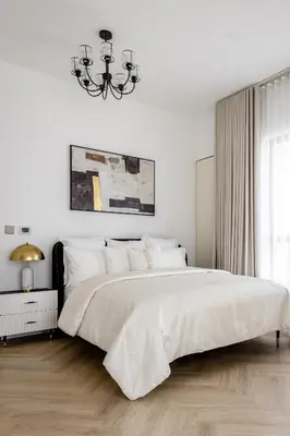 a white bedroom with a large bed and a chandelier at Beautiful 2 bed in JBR SHAMS in Dubai