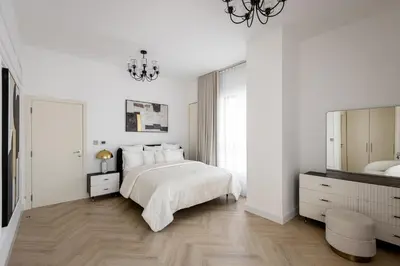 a white bedroom with a bed and a mirror at Beautiful 2 bed in JBR SHAMS in Dubai