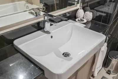 a white sink in a bathroom with a mirror at Chic Studio at ME DO RE Tower Stunning Views in Dubai