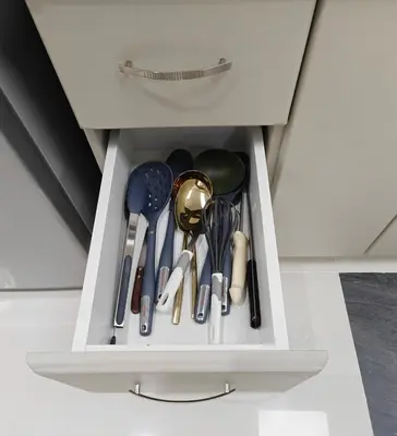 a drawer in a cabinet filled with utensils at Luxury Studio Apartment in the beautiful Dubai in Dubai