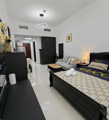 a living room with a bed and a couch at Luxury Studio Apartment in the beautiful Dubai in Dubai