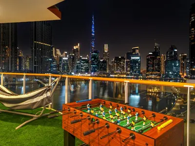 a game of chess in front of a city skyline at Stunning Burj Khalifa & Lake View 2BR with GYM and Pool in Dubai