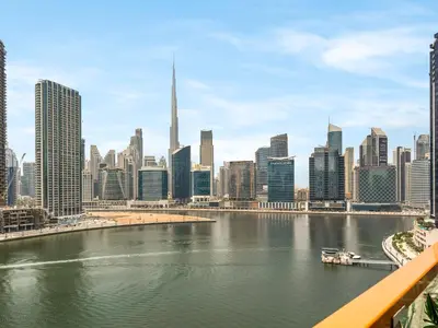 a view of a city with a river and buildings at Stunning Burj Khalifa & Lake View 2BR with GYM and Pool in Dubai