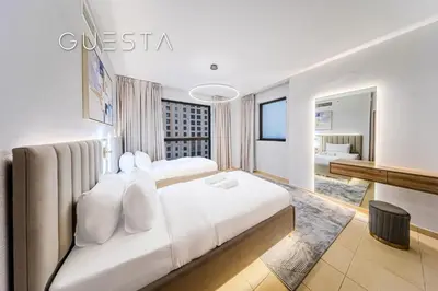 a hotel room with a large white bed and a bedroom at Jumeirah Beach Residence - Murjan 5, Dubai Marina in Dubai