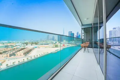 a balcony with a view of the city from a building at Elegant 2 M with Direct Canal & Iconic View in Dubai