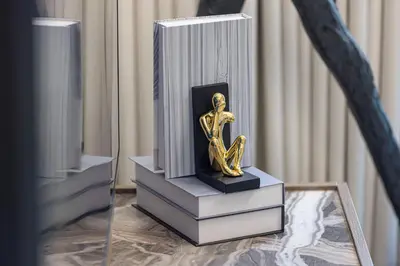a trophy sitting on top of books on a table at Luxury 1BHK Burj Khalifa & Canal View in Dubai