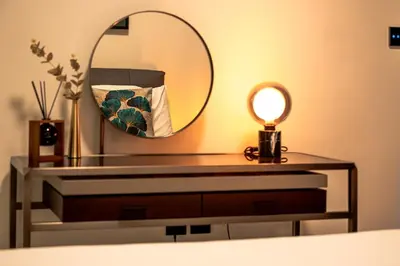 a dressing table with a mirror and a lamp at Burj Khalifa View-Beautiful Pool-Gym-Business Bay in Dubai