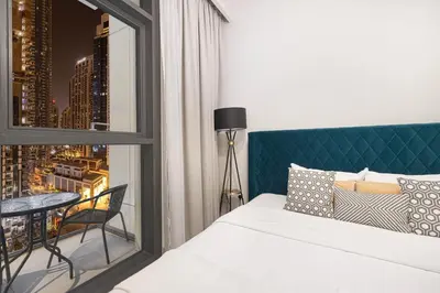 a bedroom with a bed and a view of a city at BURJ CROWN - Elegant & Spacious Two-Bedroom Apartment in Downtown Dubai, Just 10 Minutes' Walk from Dubai Mall & Dubai Fountains, Surrounded by Iconic Landmarks in Dubai